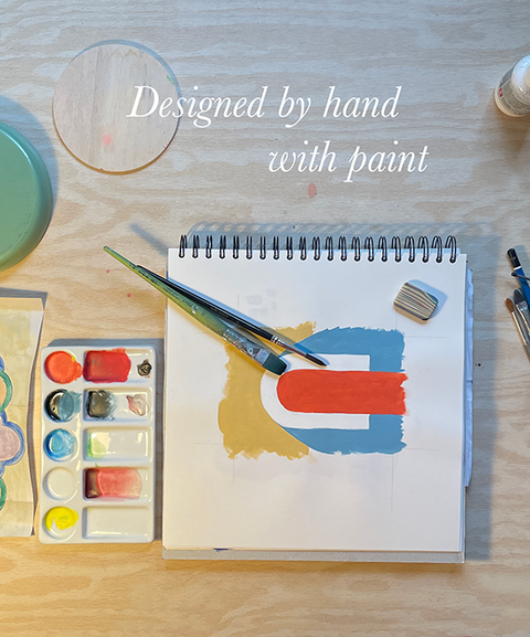 Artist’s sketchbook with colorful design, paint brushes and tools – handmade eco stationery designs from Berlin.