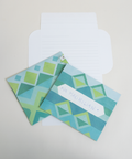 Three blue jacquard design letterfolds showing the front, back, and interior views of the design