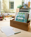Three blue jacquard design letterfolds and an open letterfold arranged in a stylish stationery desk setting.