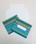 Three green stripes letterfolds showing the front, back, and interior views of the design