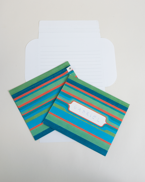 Three green stripes letterfolds showing the front, back, and interior views of the design