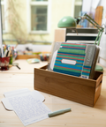 Three green stripes letterfolds and an open letterfold arranged in a stylish stationery desk setting.