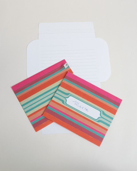 Three pink stripes letterfolds showing the front, back, and interior views of the design