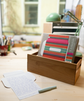 Three pink stripes letterfolds and an open letterfold arranged in a stylish stationery desk setting.