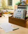 Three turquoise floral letterfolds and an open letterfold arranged in a stylish stationery desk setting.