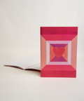 A5 notebook featuring a colorful heart design, shown from the front and open to reveal its interior.