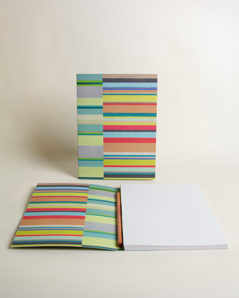 A5 notebook featuring a colorful both side stripes design, shown from the front and open to reveal its interior.