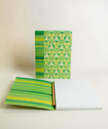 A5 notebook featuring a colorful Stained-glass flowers and stripes design, shown from the front and open to reveal its interior.