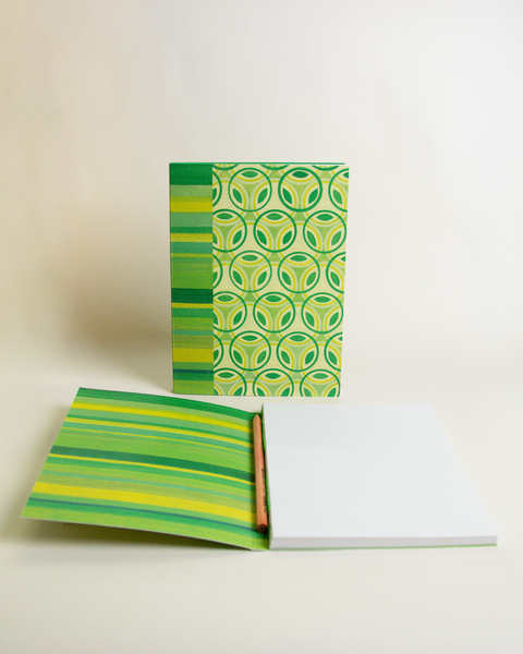 A5 notebook featuring a colorful Stained-glass flowers and stripes design, shown from the front and open to reveal its interior.