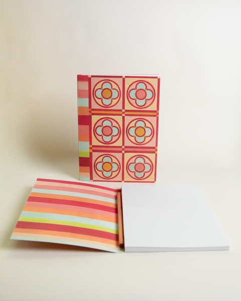 A5 notebook featuring a colorful Stained-glass flowers and stripes design, shown from the front and open to reveal its interior.