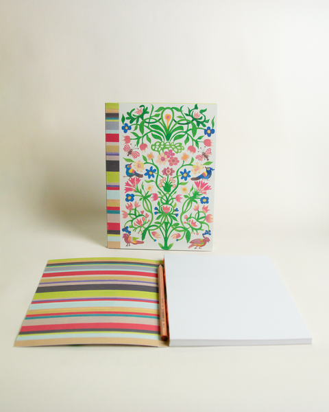 A5 notebook featuring a colorful garden and stripes design, shown from the front and open to reveal its interior.