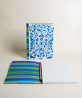 A5 notebook featuring a colorful garden and stripes in blue design, shown from the front and open to reveal its interior.