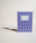 A5 notebook featuring a delicate lilac floral design, shown from the front and open to reveal its interior.