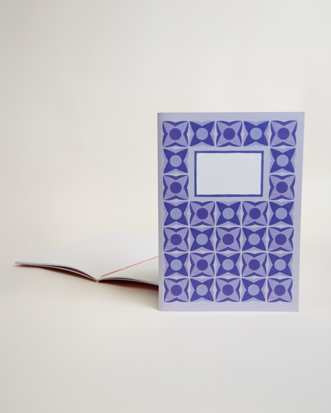 A5 notebook featuring a delicate lilac floral design, shown from the front and open to reveal its interior.