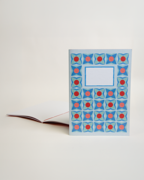 A5 notebook featuring a delicate lilac floral design, shown from the front and open to reveal its interior.