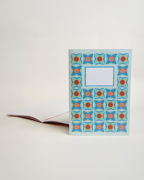 A5 notebook featuring a delicate lilac floral design, shown from the front and open to reveal its interior.