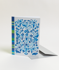Eco-friendly Circles & Stripes in blue design greeting card, angled view, printed in Berlin on recycled paper.
