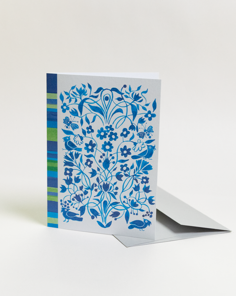 Eco-friendly Circles & Stripes in blue design greeting card, angled view, printed in Berlin on recycled paper.