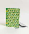 Eco-friendly Circles & Stripes-greens design greeting card, angled view, printed in Berlin on recycled paper.