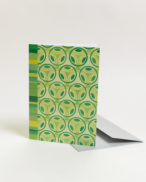 Eco-friendly Circles & Stripes-greens design greeting card, angled view, printed in Berlin on recycled paper.