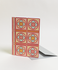 Eco-friendly Circles & Stripes-reds design greeting card, angled view, printed in Berlin on recycled paper.