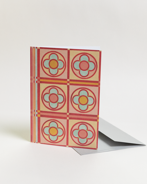 Eco-friendly Circles & Stripes-reds design greeting card, angled view, printed in Berlin on recycled paper.
