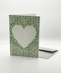 Eco-friendly lovely on green spots greeting card, 3/4 angled view, printed in Berlin on recycled paper