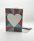Eco-friendly lovely on triangles greeting card, 3/4 angled view, printed in Berlin on recycled paper