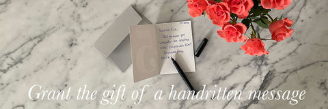 Greeting card open with handwritten message on grey envelope, decorated with flowers – eco stationery handmade in Berlin.