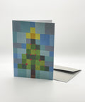 Eco-friendly X-mas tree in squares snow greeting card, 3/4 angled view, printed in Berlin on recycled paper