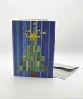 Eco-friendly X-mas tree in stripes snow greeting card, 3/4 angled view, printed in Berlin on recycled paper