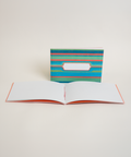 Eco-friendly notebook Green Stripes, angled view, DIN A6 recycled paper cover, handmade in Berlin