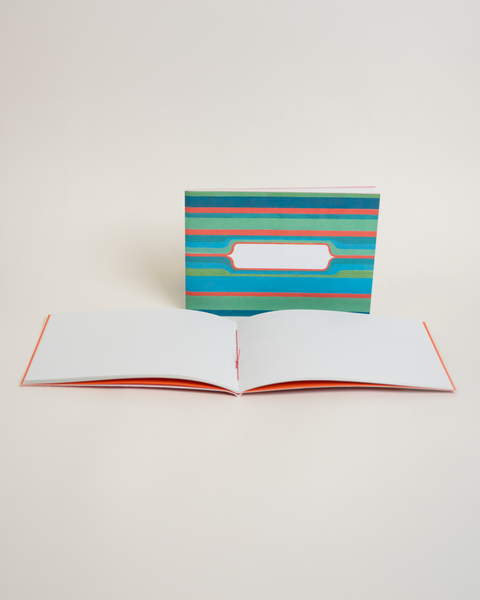 Eco-friendly notebook Green Stripes, angled view, DIN A6 recycled paper cover, handmade in Berlin
