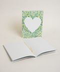 Eco-friendly notebook Lovely on green dots, angled view, DIN A6 recycled paper cover, handmade in Berlin