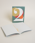 Eco-friendly notebook number 2, angled view, DIN A6 recycled paper cover, handmade in Berlin