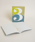 Eco-friendly notebook number 3, angled view, DIN A6 recycled paper cover, handmade in Berlin