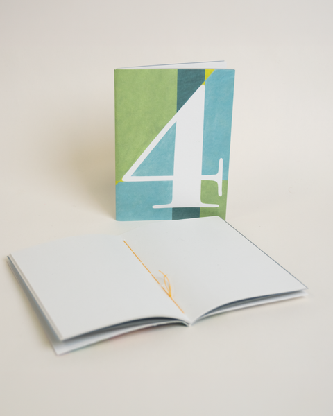 Eco-friendly notebook number 4, angled view, DIN A6 recycled paper cover, handmade in Berlin