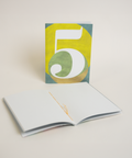 Eco-friendly notebook number 5, angled view, DIN A6 recycled paper cover, handmade in Berlin