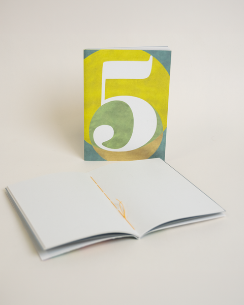 Eco-friendly notebook number 5, angled view, DIN A6 recycled paper cover, handmade in Berlin