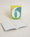 Eco-friendly notebook number 6, angled view, DIN A6 recycled paper cover, handmade in Berlin