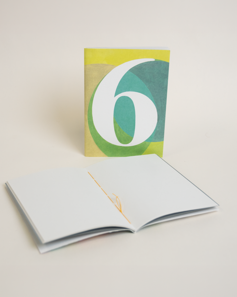 Eco-friendly notebook number 6, angled view, DIN A6 recycled paper cover, handmade in Berlin