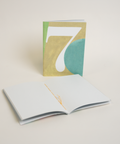 Eco-friendly notebook number 7, angled view, DIN A6 recycled paper cover, handmade in Berlin