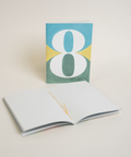 Eco-friendly notebook number 8, angled view, DIN A6 recycled paper cover, handmade in Berlin