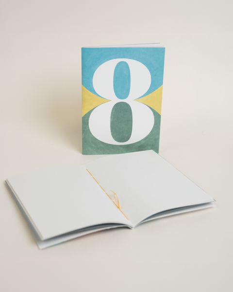 Eco-friendly notebook number 8, angled view, DIN A6 recycled paper cover, handmade in Berlin
