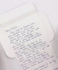 Video of Turquoise flowers letterfold being folded into an envelope, eco stationery