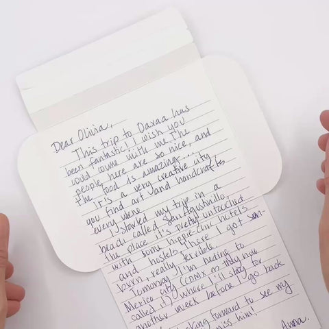 Video of Turquoise flowers letterfold being folded into an envelope, eco stationery