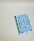Eco-friendly notebook garden and stripes in blue design, DIN A5 recycled paper cover, zoom in handbound detail, handmade in Berlin