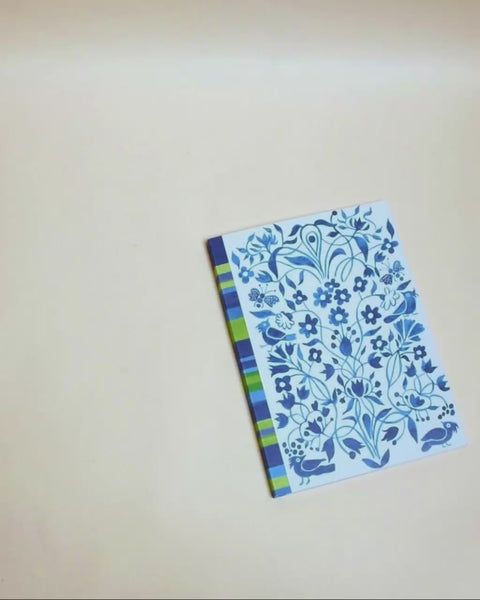 Eco-friendly notebook garden and stripes in blue design, DIN A5 recycled paper cover, zoom in handbound detail, handmade in Berlin