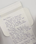Video of Turquoise flowers letterfold being folded into an envelope, eco stationery