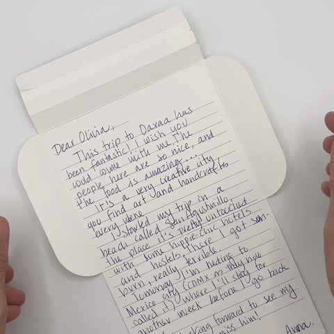 Video of Turquoise flowers letterfold being folded into an envelope, eco stationery